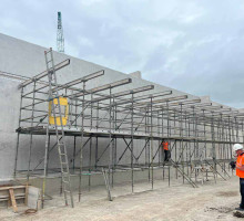 Scaffolding surrounding concrete wall