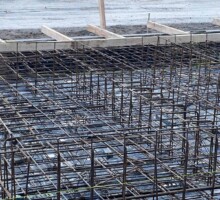 Pouring reinforced concrete into formwork molds